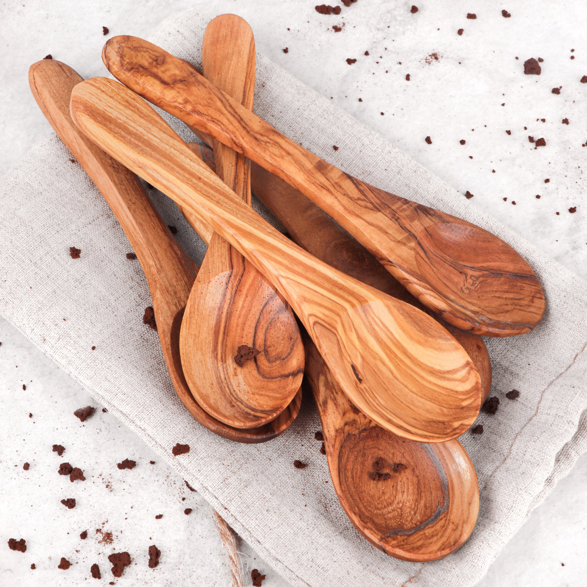 Versatile and compact olive wood spoon, skillfully handcrafted for various culinary uses. Whether for coffee or condiments, its refined rustic look enhances any kitchen décor, making it a must-have for gourmet enthusiasts.