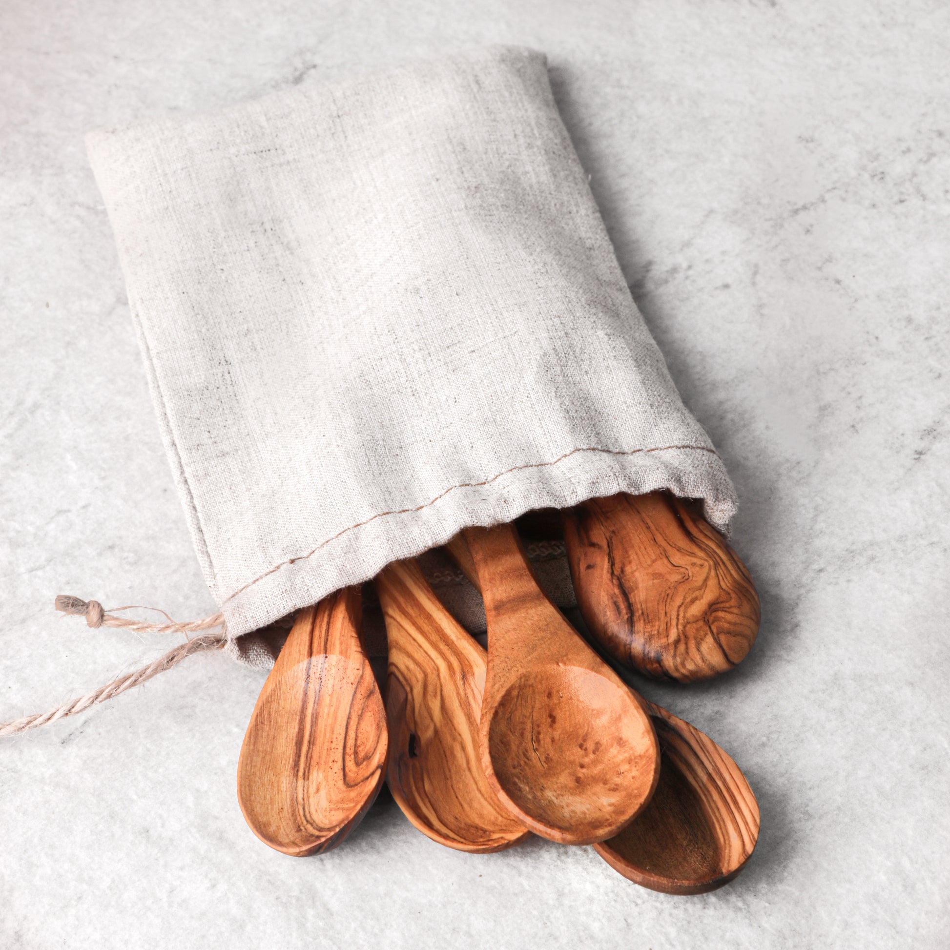 Eco-conscious small spoon handmade from olive wood, a sustainable choice for eco-friendly kitchens. With care instructions for longevity, this spoon is not just a utensil but a piece of art that adds a touch of nature to your culinary tools.