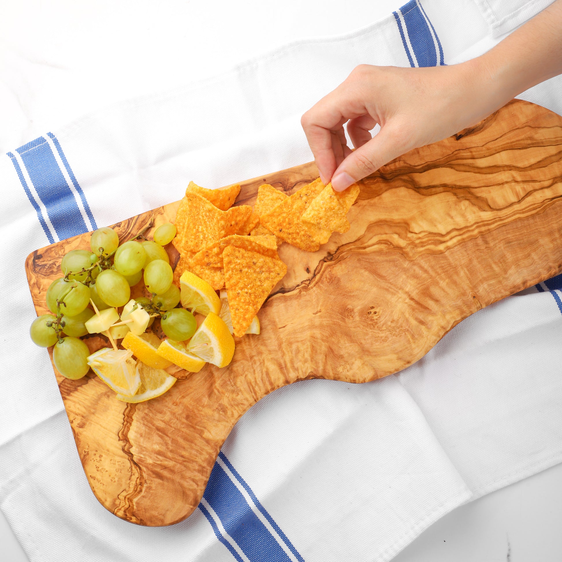 Versatile Olive Wood Board for Charcuterie and More: This board’s large surface area is perfect for a custom cheese spread, serving as a functional piece for special occasions and an everyday cutting board, enhancing any culinary experience.