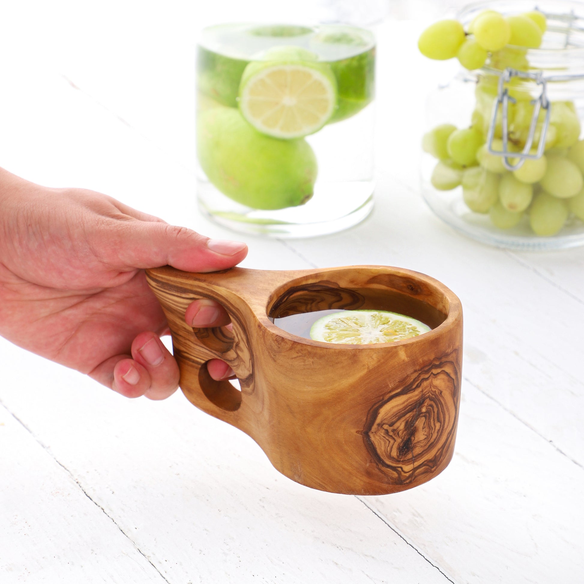 Rustic Olive Wood Guksi with a smooth, contoured body and sturdy handle, handcrafted for a personalized drinking experience. Its distinctive wood grain ensures no two cups are the same.