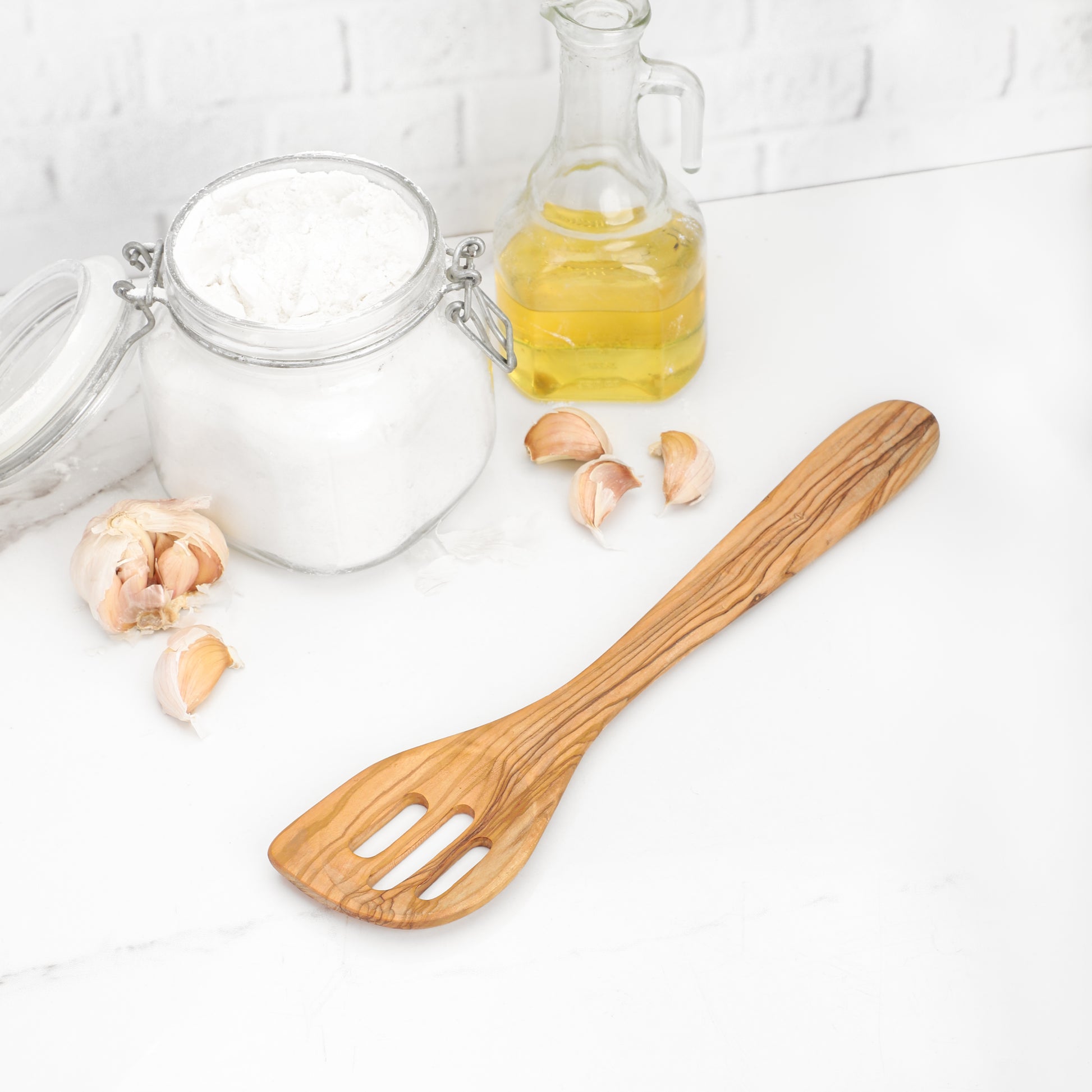 Premium Olive Wood Slotted Spatula, hand-made with care. Perfect for food enthusiasts seeking a blend of style and practicality in their kitchen utensils, this spatula excels in performance and longevity, featuring a stunning natural pattern.
