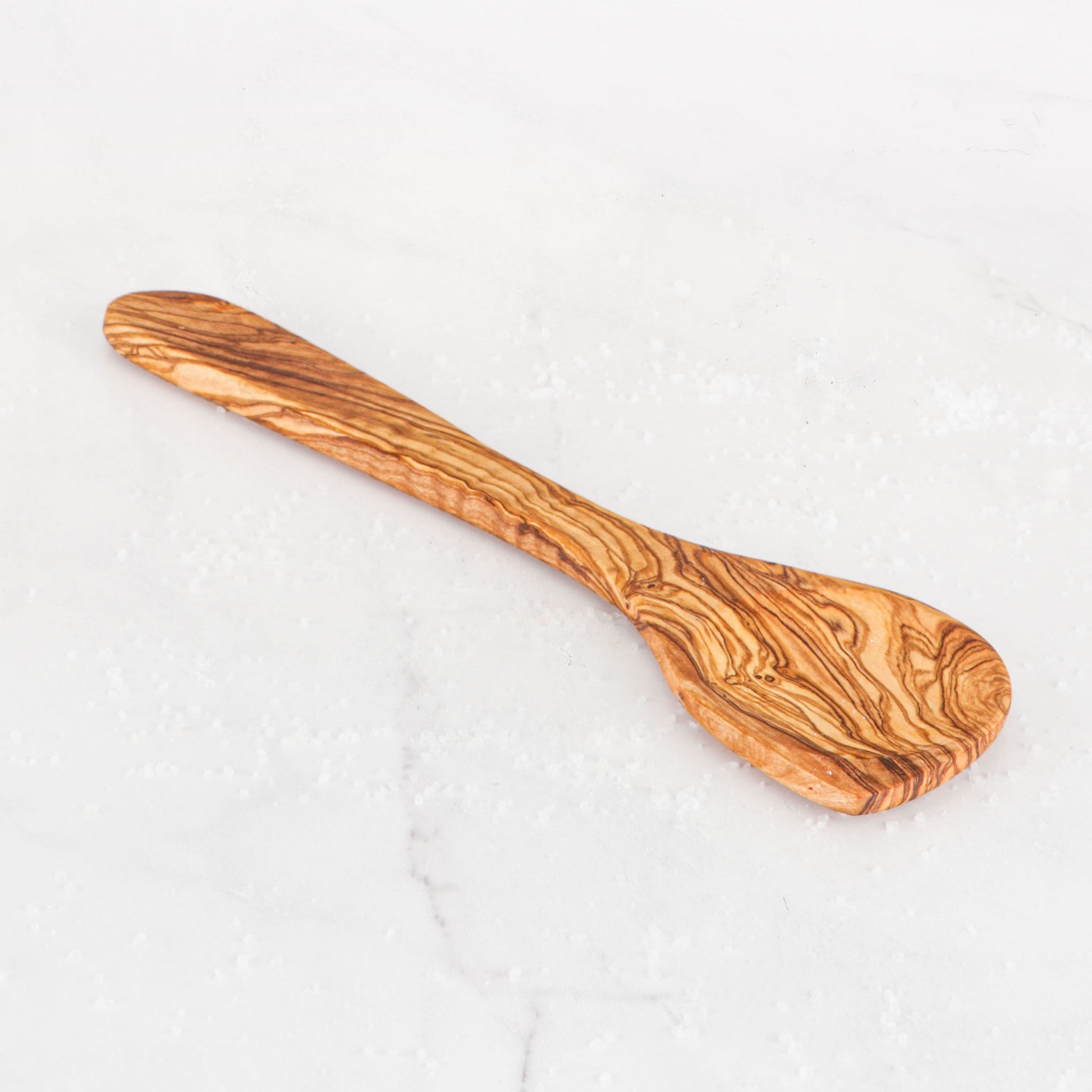 Discover the natural beauty of our Olive Wood Corner Spoon, a must-have wooden kitchen utensil. Each spoon is hand-carved, offering a unique, durable tool for stirring, mixing, and more, enhancing your cooking experience with its elegant design.