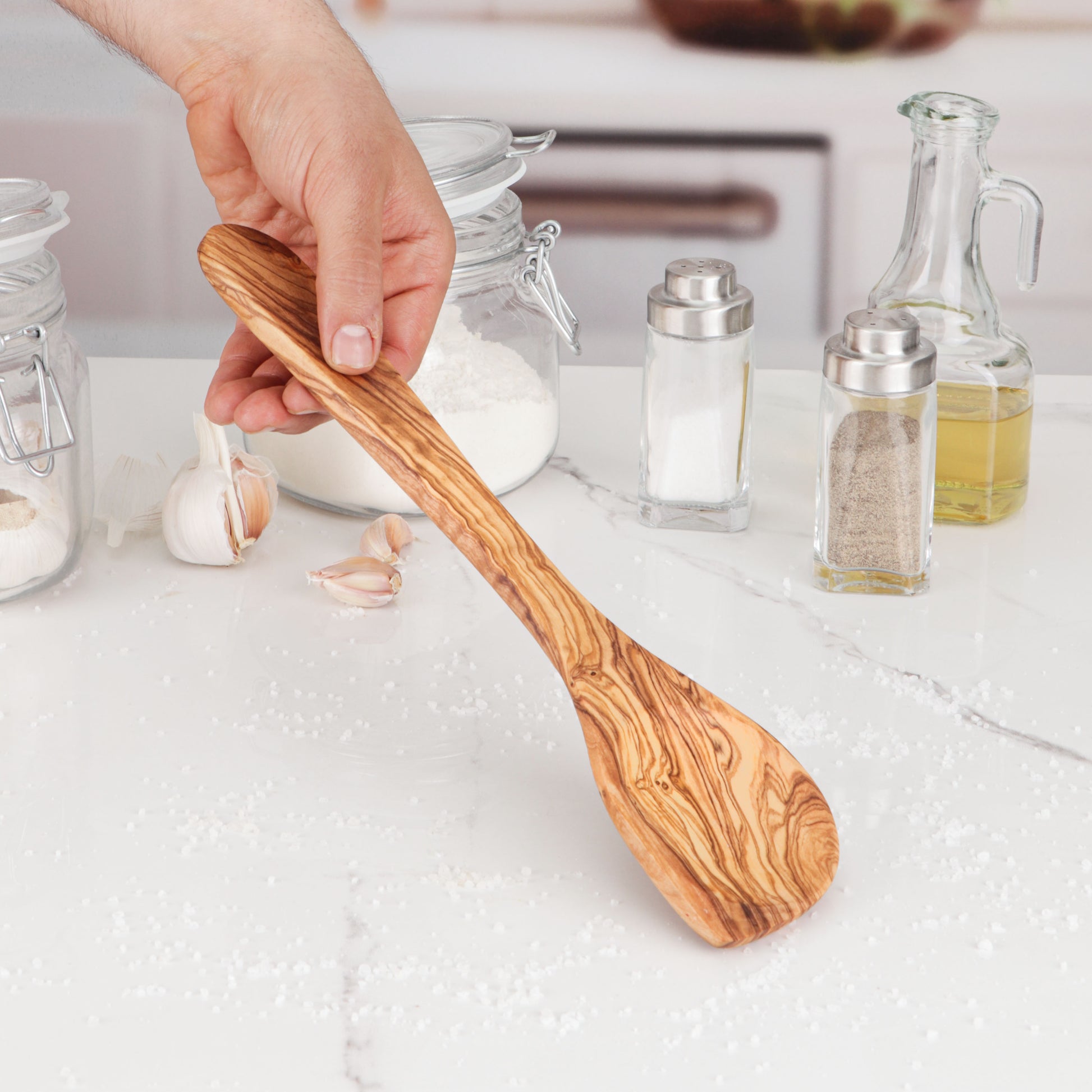 Elegant Olive Wood Cooking Utensil, designed for versatility in the kitchen. This corner spoon's ergonomic shape ensures comfortable stirring and scraping, making cooking easier. Handcrafted to last, it's an essential tool for every home cook.