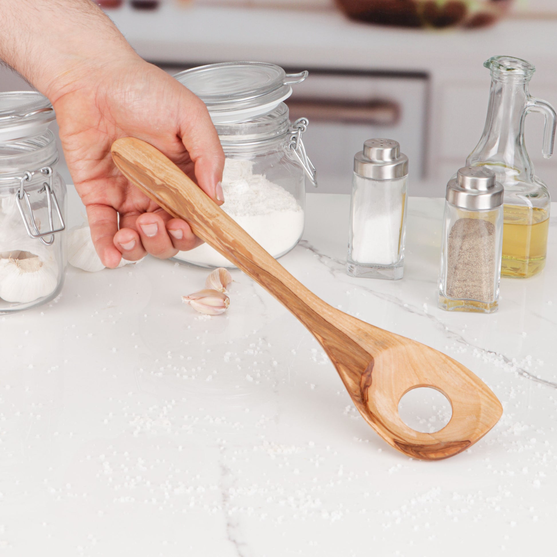 Durable and versatile olive wood cooking spoon, specifically designed for risotto but suitable for various cooking tasks. The ergonomic design and smooth finish of this hand-carved utensil make it comfortable for stirring, mixing, and serving. Revel in the natural beauty and unique patterns of olive wood that add a touch of warmth to your kitchen, ensuring no two spoons are alike, making each use a joy.