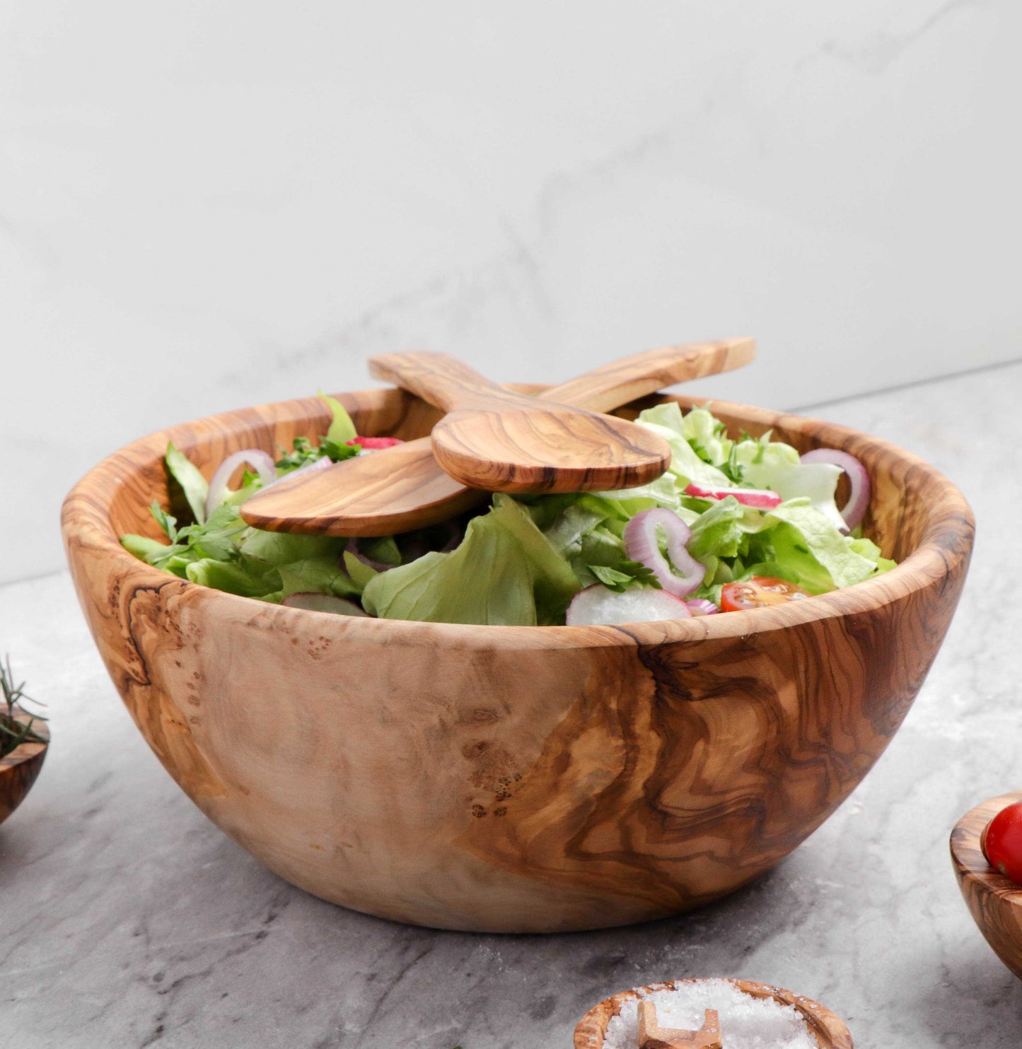 Artisan-crafted Large Olive Wood Bowl, with its rich, natural patterns, stands out as a multifunctional piece for salads, fruits, or as an elegant home décor item, enhancing your kitchen's aesthetic.