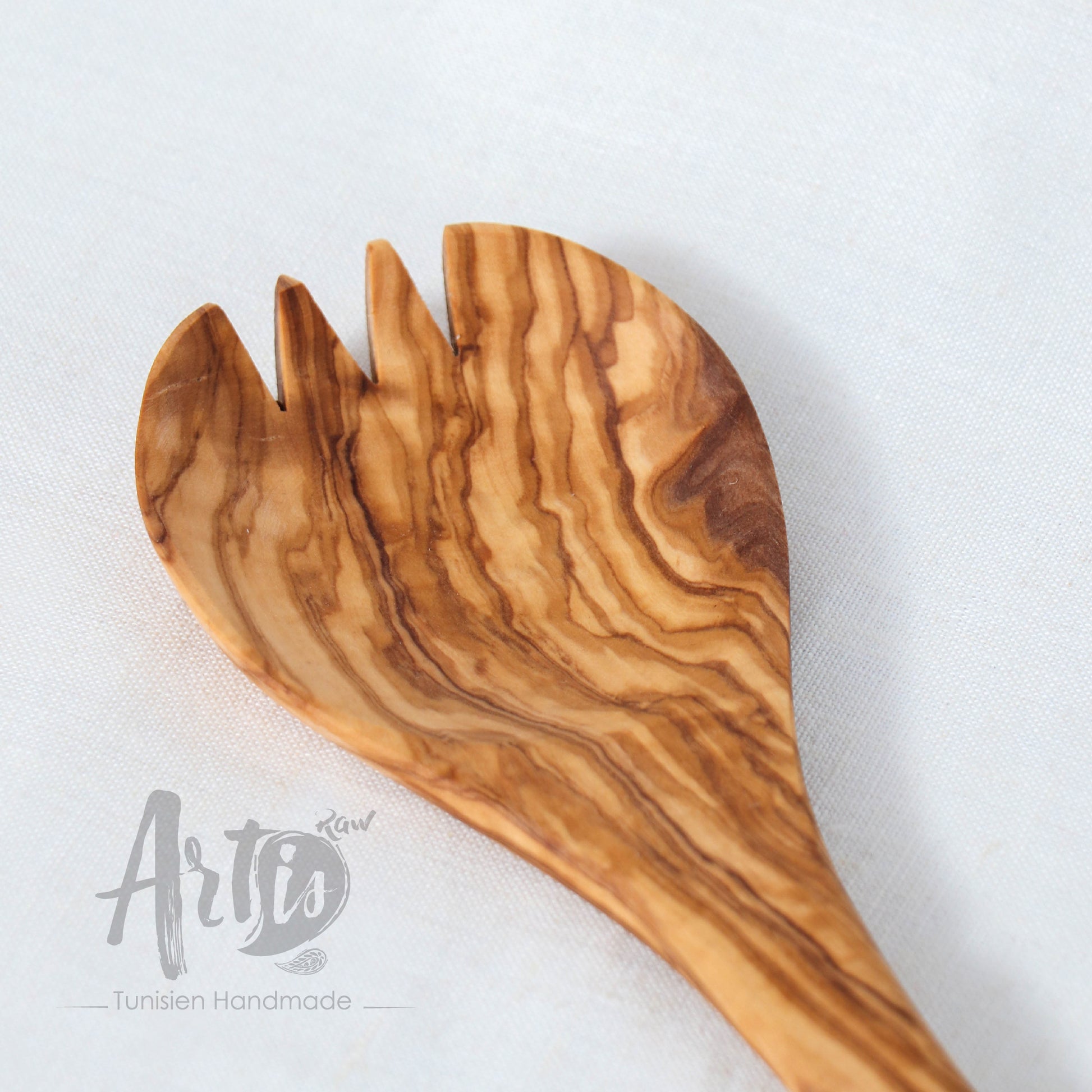 Handcrafted olive wood spork, a fusion of spoon and fork, perfect for enhancing your serving ensemble. Its innovative design caters to a range of dishes, making it an essential for anyone who values the combination of style, practicality, and environmental responsibility in their wooden utensils and flatware.