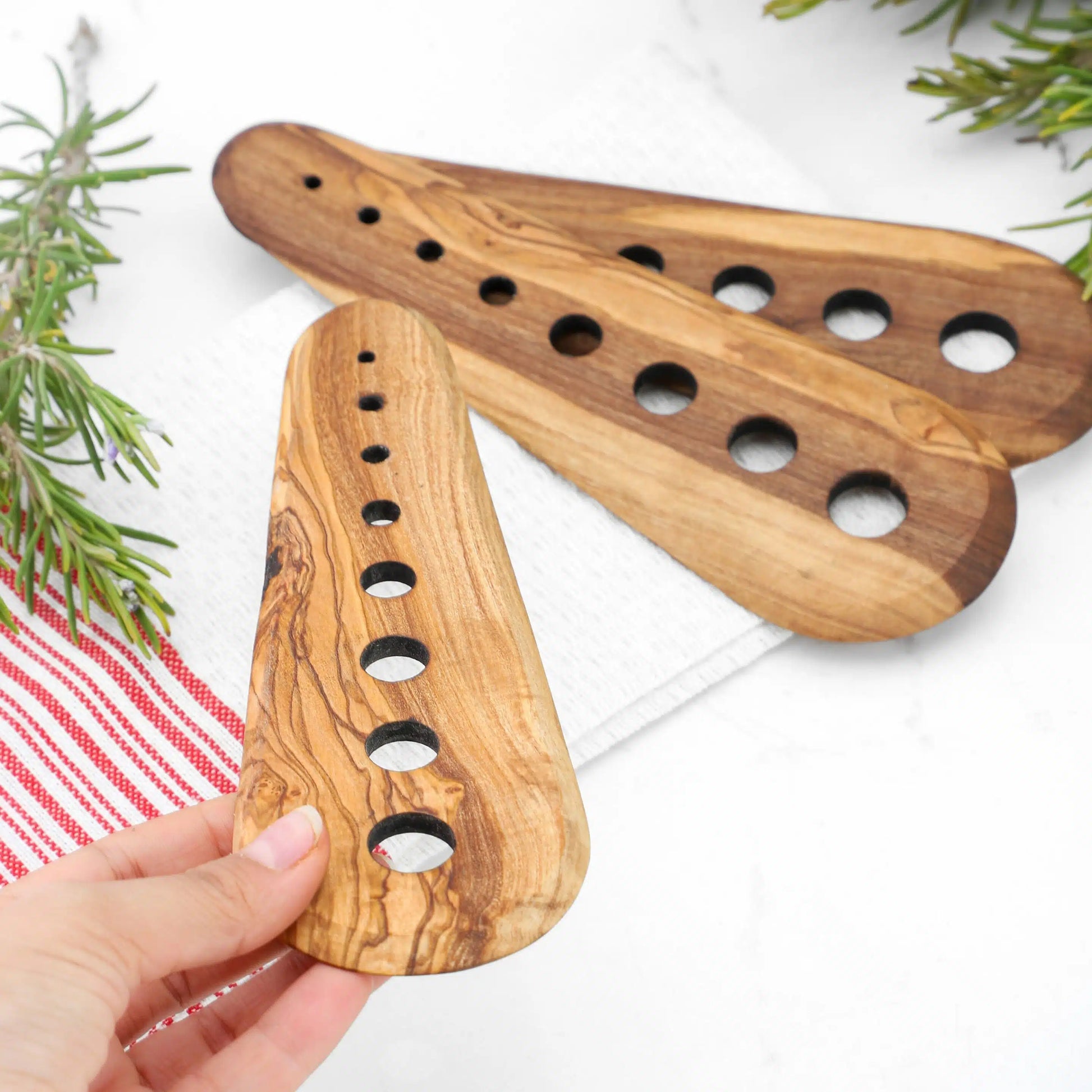 Side angle of durable Tunisian olive wood herb stripper with smooth handle
