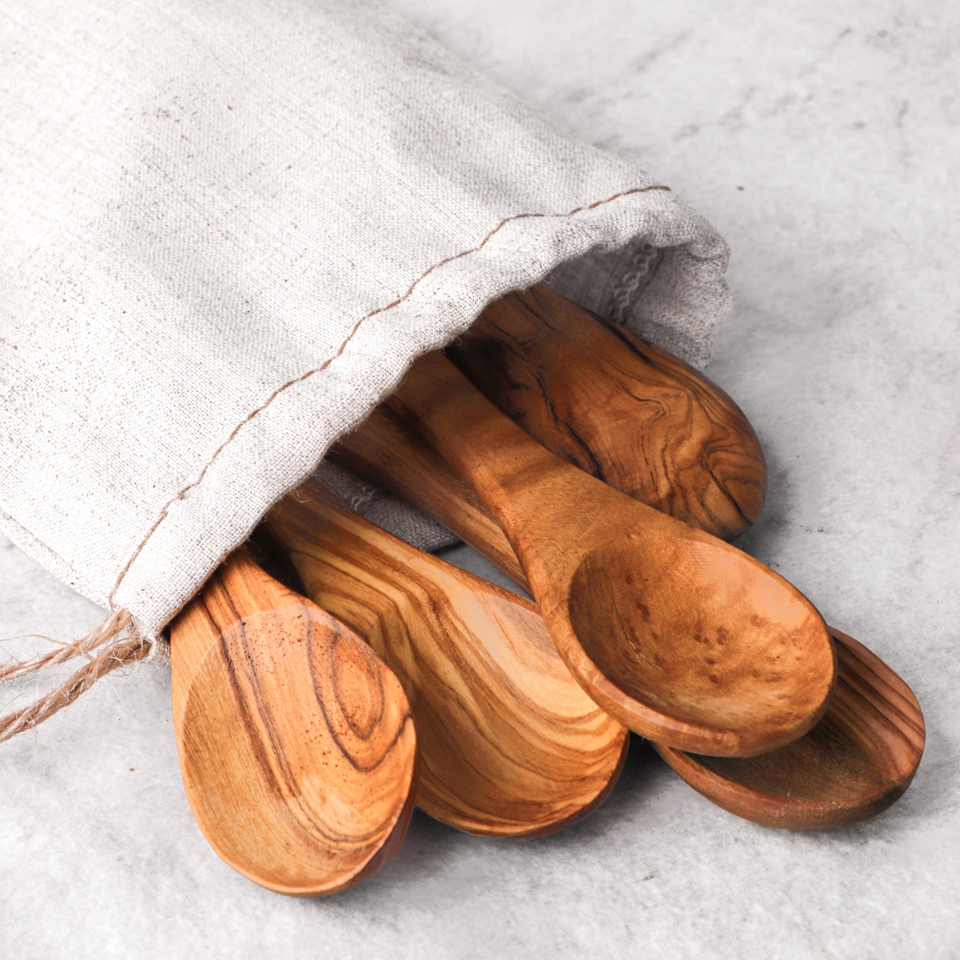 Durable mini wooden spoons made from olive wood, showcasing the material's natural beauty and unique grain patterns. Perfect for coffee, salt, and condiments, these spoons combine practicality with rustic elegance for any occasion