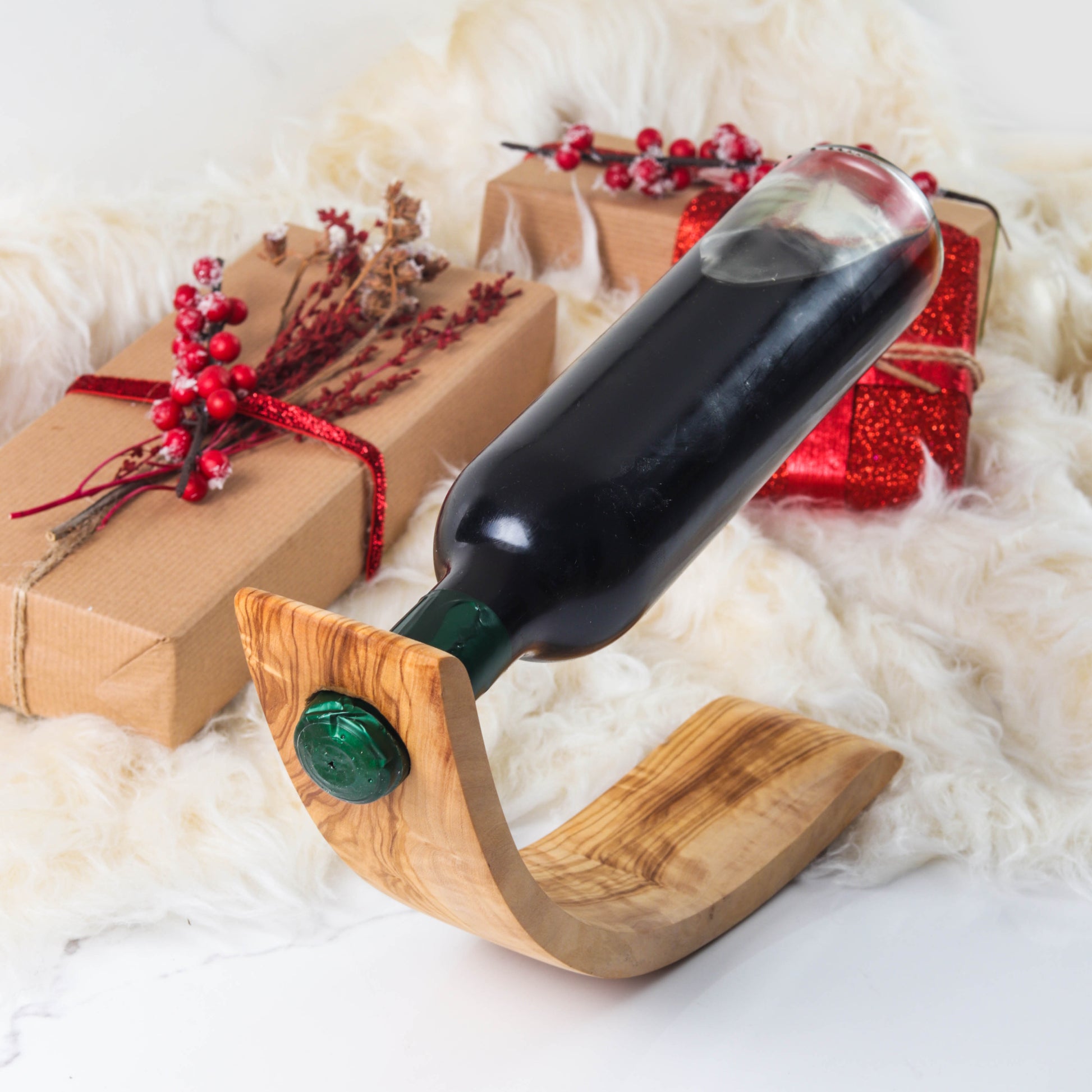 Stylish Wooden Bottle Holder crafted from durable olive wood, showcasing natural patterns. This versatile piece serves as a practical bottle stand and an elegant home decoration, adding sophistication to dining tables and countertops.