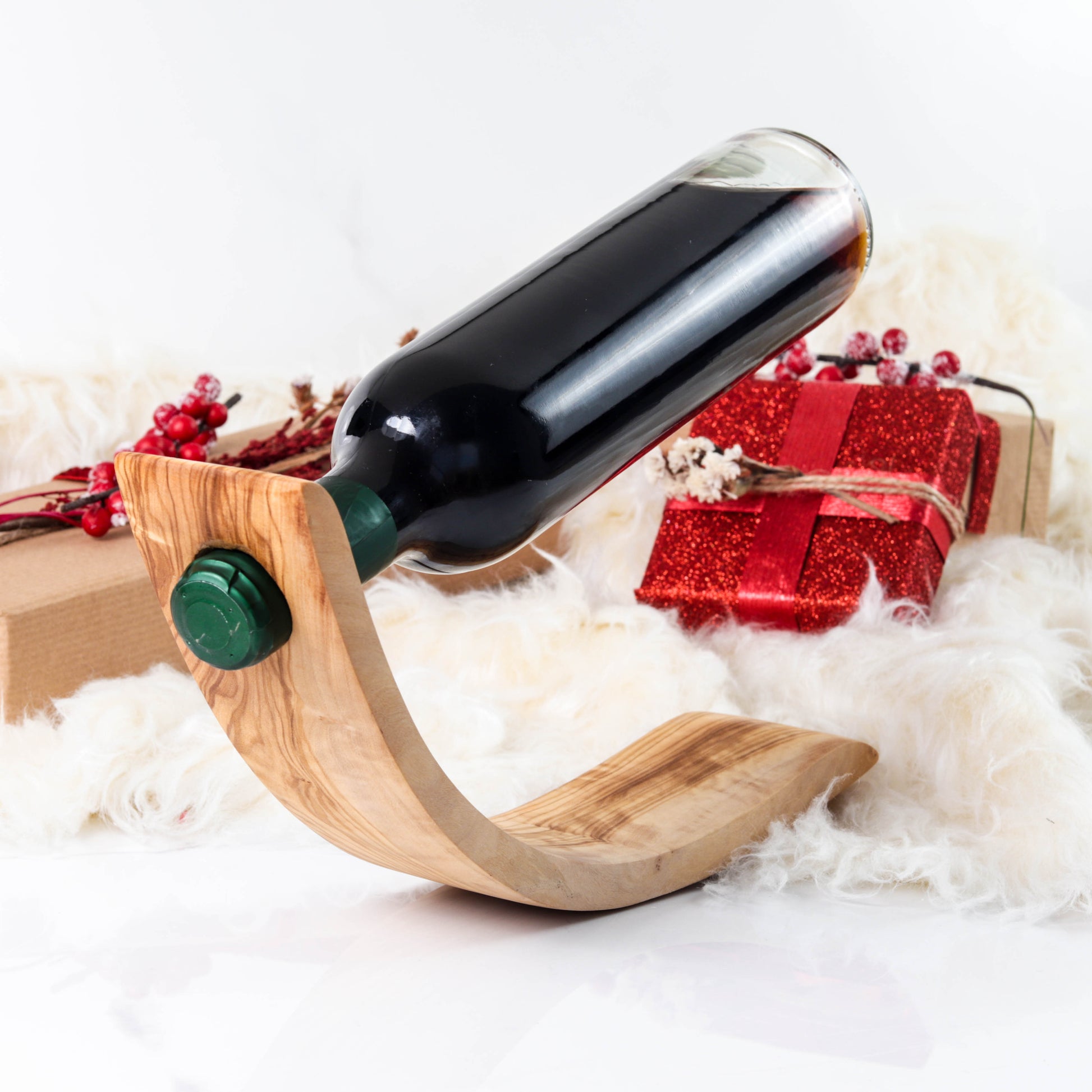 Handmade Olive Wood Bottle Holder: A perfect blend of elegance and practicality. This unique bottle butler securely holds your wine, enhancing your space with its natural beauty and sturdy design. Ideal for any decor, from rustic to modern.